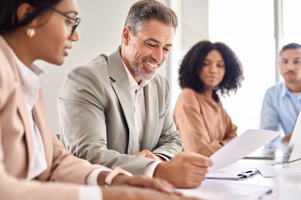 Happy business man checking law document at legal advice meeting.